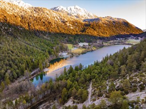 Late evening view of a lake with autumnal trees and a mountain, Thum See, Bad Reichenhall, Bavaria,