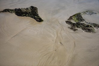 Seawater run-off leaves traces in the sand on Fazayat beach in Al Hauta, Dhofar province, Arabian