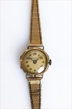 Antique gold wristwatch on a white background