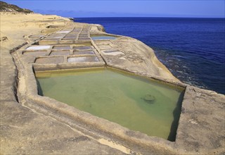 Historic ancient salt pans on coast near Marsalforn, island of Gozo, Malta, Europe