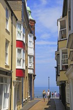 Sea view past historic houses in street, Cromer, Norfolk, England, UK