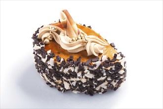 Cake with chocolate chips and cream decorations isolated on white background. close up