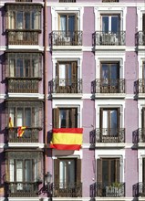 Geometric pattern of historic apartments with national flag, Calle de Bailen, Madrid city centre,