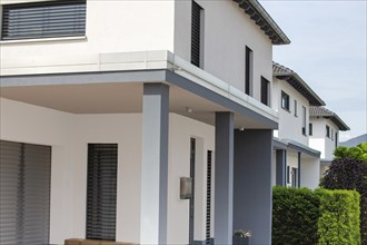 Symbolic image of real estate: Detail of modern white detached houses in a new development area