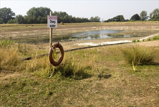 27 July 2018 Low water level in farm irrigation lake after long summer drought, Sutton, Suffolk