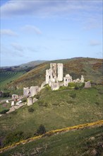 Corfe Castle is located in a natural defensive site on a hill between chalk ridges and for a