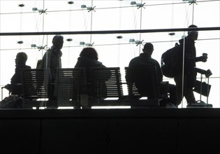 Deutsche Bahn passengers sitting on a bench at Berlin Central Station, 26/09/2016