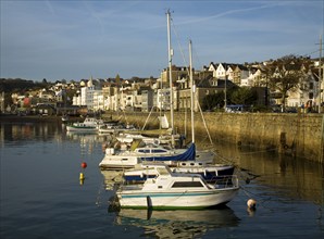 Boats in the harbour and the town of St Peter Port, Guernsey, Channel Islands, UK, Europe