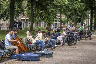 Park at the Hofvijver, opposite the historic Binnenhof, seat of the Dutch government, people taking