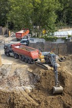 Construction work, excavating a building pit for a residential building