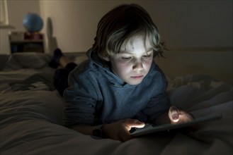 A boy plays computer games on a tablet PC