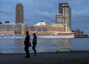 Cruise ship Aida Prima at the Cruise Terminal of Rotterdam, Kop van Zuid, skyscrapers at the