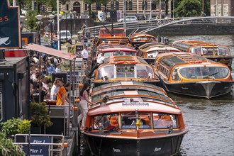 Canal cruises, pier of Lovers Canal Cruises, at Amsterdam Centraal station, Amsterdam Netherlands