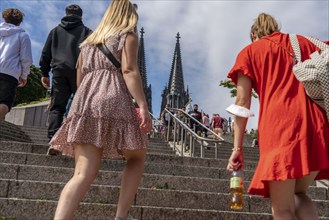 Tourists, visitors, at the ascent from the banks of the Rhine to the cathedral level, Cologne