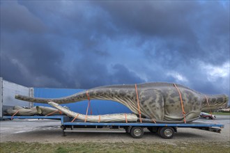 Large dinosaur figure loaded in parts on a heavy goods vehicle, Lauf an der Pegnitz, Middle