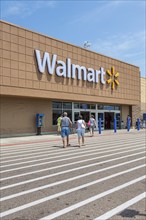 Shoppers entering the Walmart shopping center in Biloxi, Mississippi, USA, North America