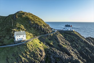 Aerial view of Krakenes Fyr lighthouse, lighthouse located on steep cliff, norwegian coast north of