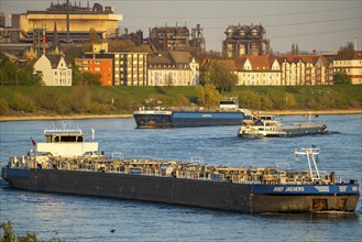 Cargo ships on the Rhine near Duisburg-Laar, houses on Deichstraße, industrial backdrop of the