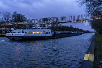 Slinky Springs to Fame pedestrian bridge over the Rhine-Herne Canal near Oberhausen, cargo ship,