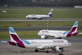 Düsseldorf Airport, SunExpress Boeing 737 on landing, Eurowings Airbus in parking position, outside