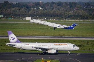 Düsseldorf Airport, SAS Scandinavia Bombardier CRJ-900 on take-off, Freebird Airbus A320 on the