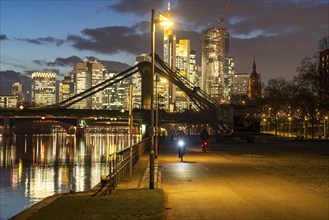 Skyline of the city centre of Frankfurt am Main, cyclist with light on the cycle path, pavement,