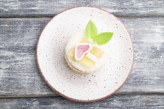 Decorated cake with milk and coconut cream on a gray wooden background. top view, flat lay, close