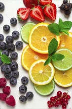 Mix of fruits and berries, set, assortment, sliced citrus fruits, raspberries, blueberries, mint