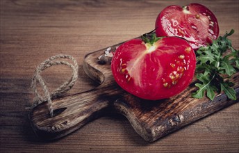 Sliced tomato, on a wooden chopping board, food background, no people