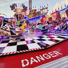 People on the illuminated carousel Break Dance in the evening, Cranger Kirmes, Herne, Ruhr area,