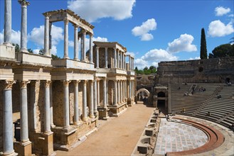 View of an ancient Roman theatre with marble columns and preserved ruins under a sunny sky, Teatro