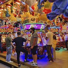 People in an illuminated pusher arcade in the evening, Cranger Kirmes, Herne, Ruhr area, North