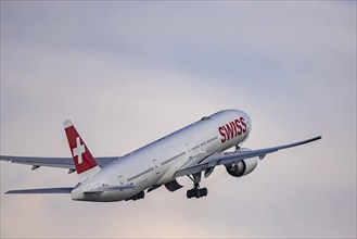 Aircraft taking off at Zurich Airport. Registration: HB-JNK, airline SWISS, BOEING 777-300ER.