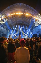 Crowd at a night concert with intense blue lights on stage, Klostersommer, Calw Hirsau, Black