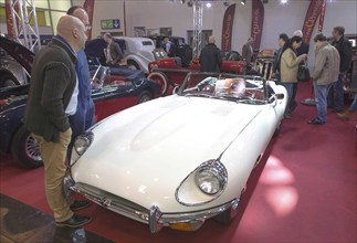 Visitors to Techno Classica take a look at a Jaguar E Type. Techno Classica is the trade fair for