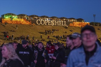 Copenhagen, Denmark - 19 June 2024: Festivalgoers in front of the logo at the Copenhell Metal