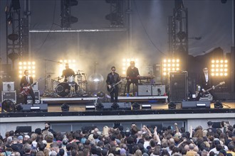 Daniel Kessler (guitarist), Samuel Sam Fogarino (drummer), Paul Banks (singer), Brandon Curtis