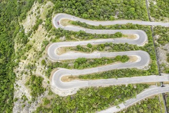 Aerial view, drone shot, Mountain pass road with multiple hairpins, water pipeline, Switzerland,