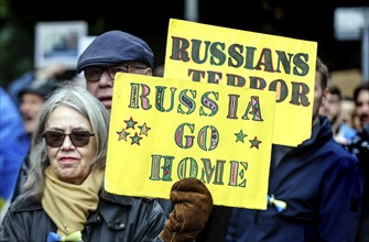 Ukrainians holding placards with the slogan Russia go home at the counter-demonstration Your peace