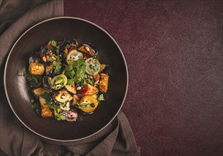 Warm Salad, Saksuka, with crispy eggplant, and tomatoes, spices, herbs, sesame seeds, sunflower