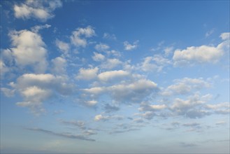 Fleecy clouds adorn the blue evening sky