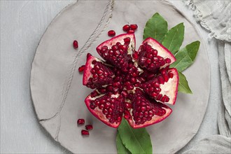 Fresh, cut pomegranate fruit, on a gray background, food concept, top view, no people