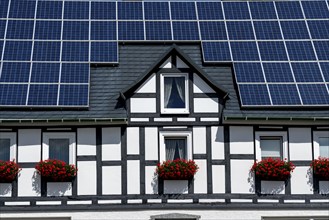 Half-timbered house with a solar roof, solar modules on the pitched roof, near Bad Berleburg, North