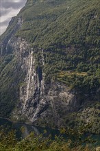 The dramatic Seven Sisters waterfall plunges into the Gairangerfjord in Norway Europe, surrounded