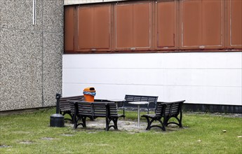 Benches, a table and a wastepaper basket in an outdoor break area on a factory site, Berlin,