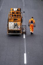 Marking work after the application of new whisper asphalt surface for the A40 motorway, in the