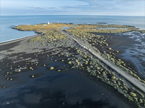 Aerial view of black lava beach, lighthouse and NATO radar station, Stokksnes, east of Höfn, East