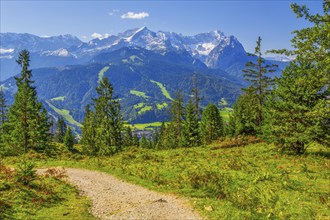 Hiking trail on the Wank 1780m with views of the valley and Zugspitze group 2962m,