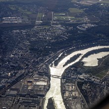 River flowing through a city with bridges and industrial areas, flight, aerial view