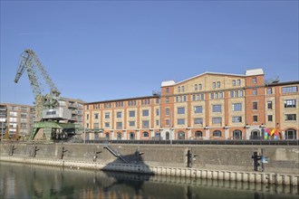 Old wine warehouse with harbour crane, quay, quay wall, gantry crane, container crane, shipyard